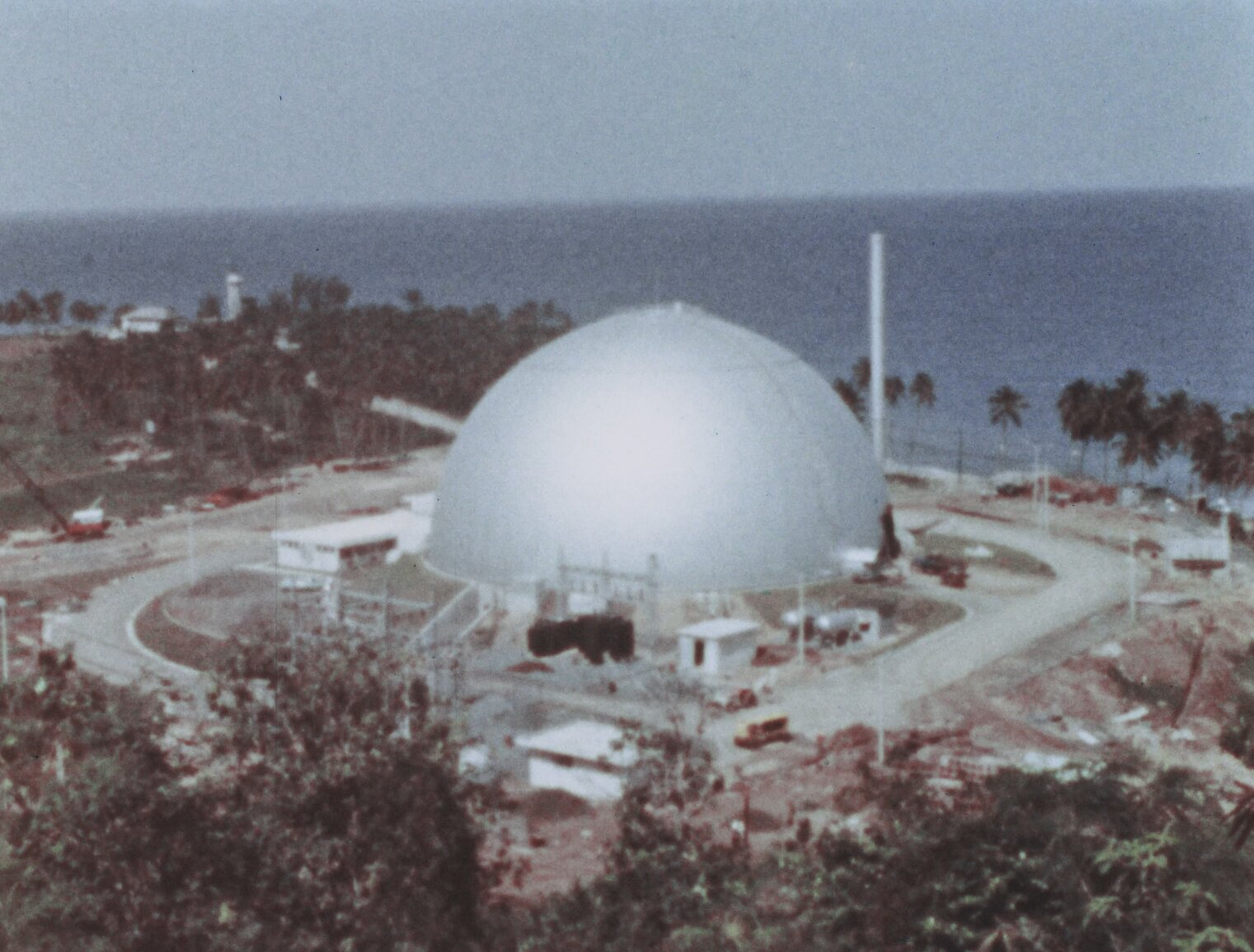 A completed view of the BONUS dome with ocean and palm trees in the background.