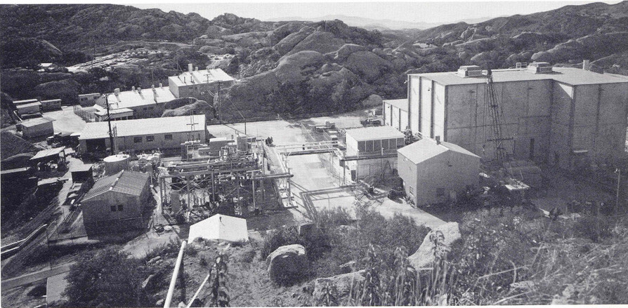 Mountainous terrain of with several high-tech buildings