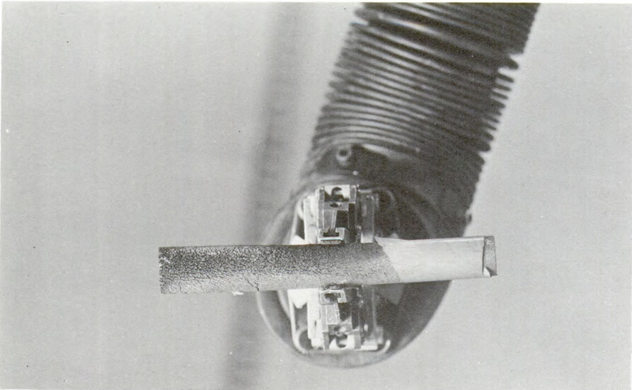 A picture of a damaged nuclear fuel rod held by a manipulator from the sodium reactor experiment