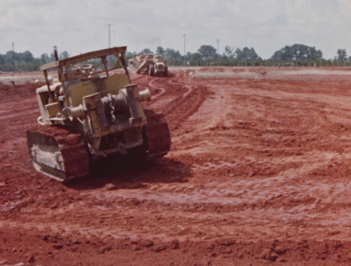 Equipment clearing land for construction