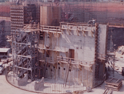 The reactor building used reinforced concrete below grade and a reinforced shell above grade